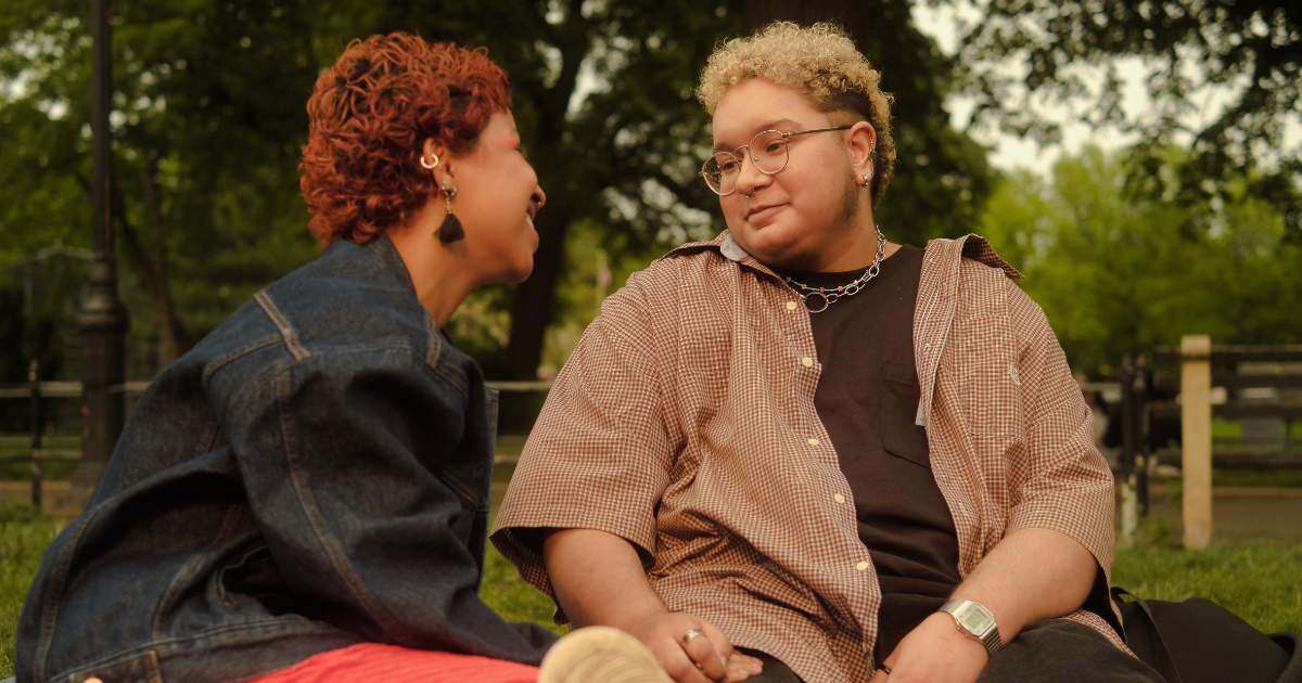 A trans couple sharing a moment in the park